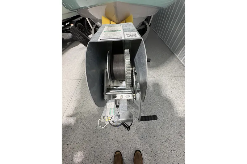 Slide: The Image of 2023 Yamaha Boats 222 FSH Sport on trailer, close-up view of hull and wheel. - 25