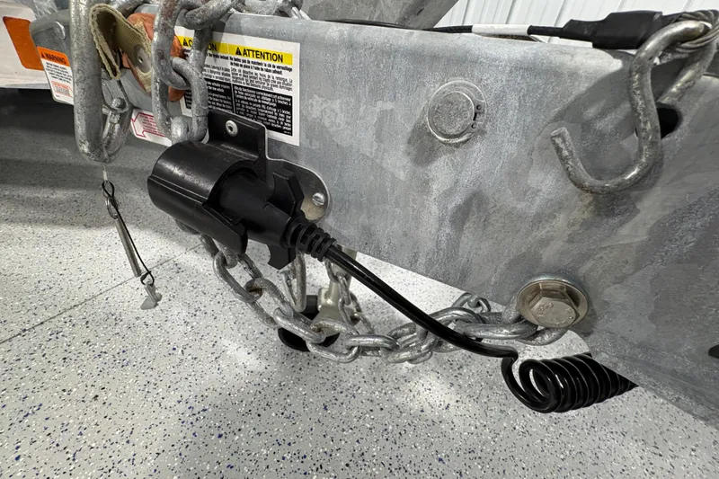 Slide: The Image of Trailer wheels of a 2023 Yamaha Boats 222 FSH Sport, parked indoors. - 27