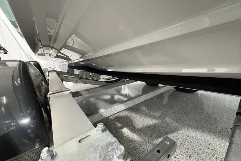 Slide: The Image of 2023 Yamaha Boats 222 FSH Sport on trailer, sleek design, light blue hull. - 29