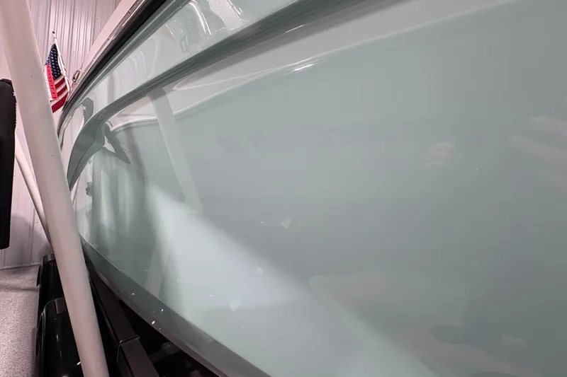 Slide: The Image of 2023 Yamaha Boats 222 FSH Sport in a showroom with American flag. - 31