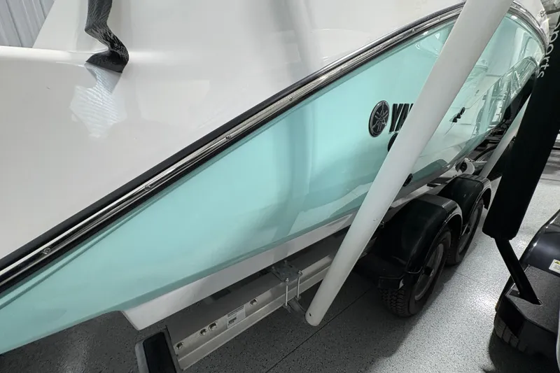 Slide: The Image of Close-up of 2023 Yamaha Boats 222 FSH Sport rudder in a garage setting. - 34