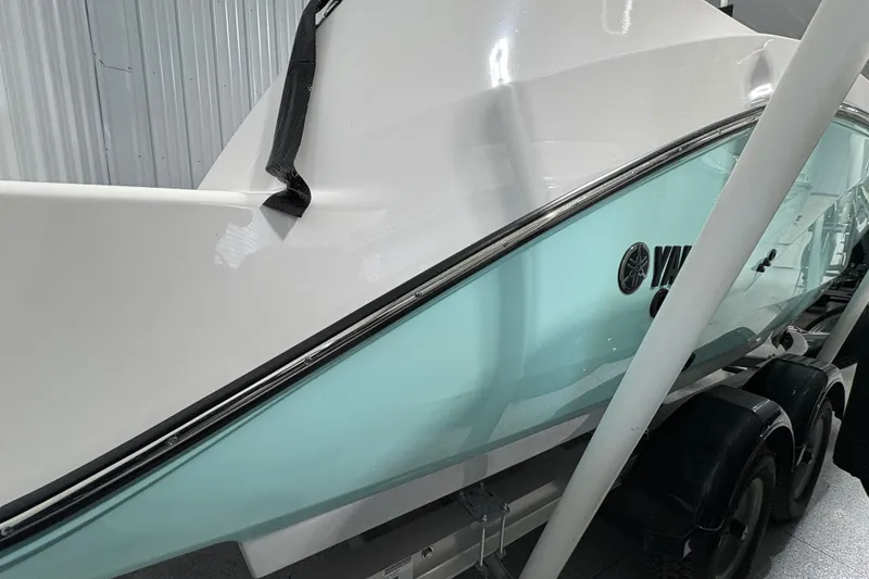 Slide: The Image of 2023 Yamaha Boats 222 FSH Sport jet propulsion system close-up in a garage. - 35