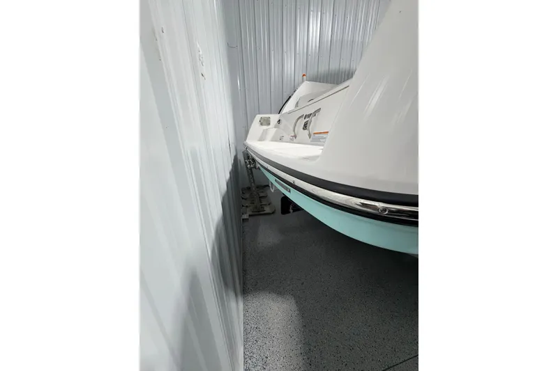 Slide: The Image of 2023 Yamaha Boats 222 FSH Sport on trailer, close-up of hull and trailer components. - 37