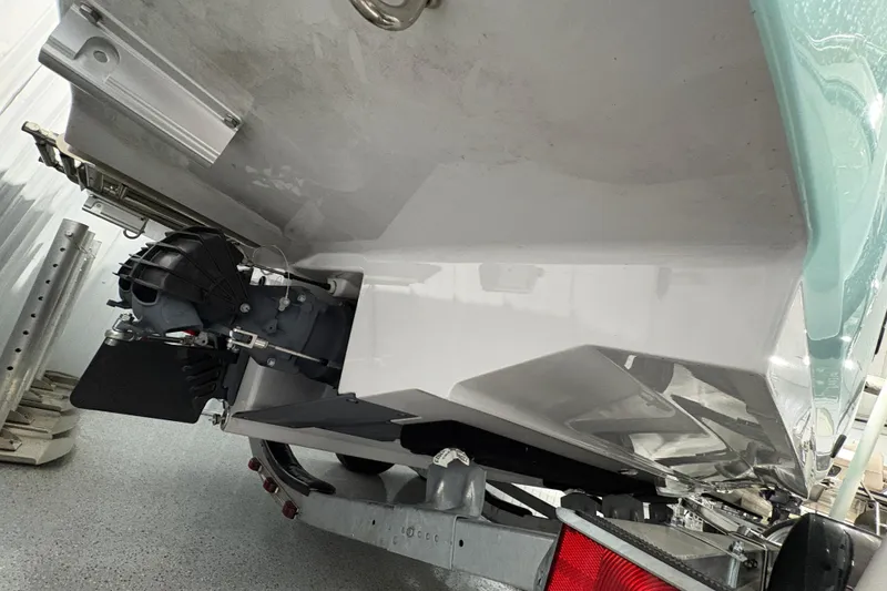 Slide: The Image of 2023 Yamaha Boats 222 FSH Sport interior detail with white and black seating. - 41