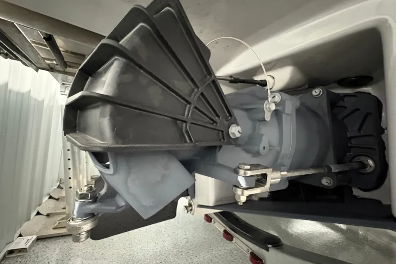 Slide: The Image of 2023 Yamaha Boats 222 FSH Sport interior detail with metal plate and cup holder. - 42