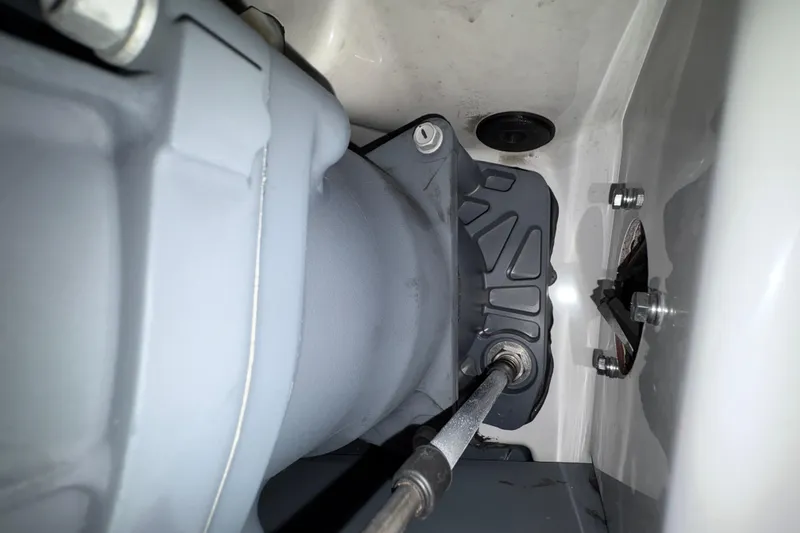 Slide: The Image of 2023 Yamaha Boats 222 FSH Sport interior with open storage compartment and American flag. - 43