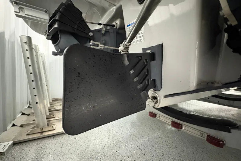 Slide: The Image of 2023 Yamaha Boats 222 FSH Sport livewell with blue coiled hose and drain. - 44