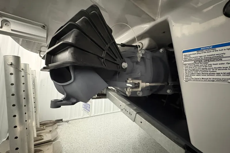 Slide: The Image of 2023 Yamaha Boats 222 FSH Sport interior with seating and storage, in a well-lit garage. - 45