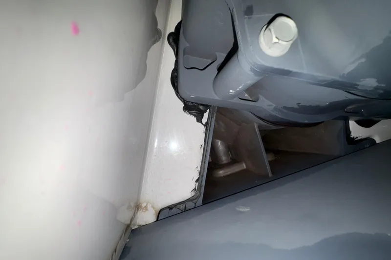 Slide: The Image of 2023 Yamaha Boats 222 FSH Sport interior with seating and T-top in a showroom. - 46