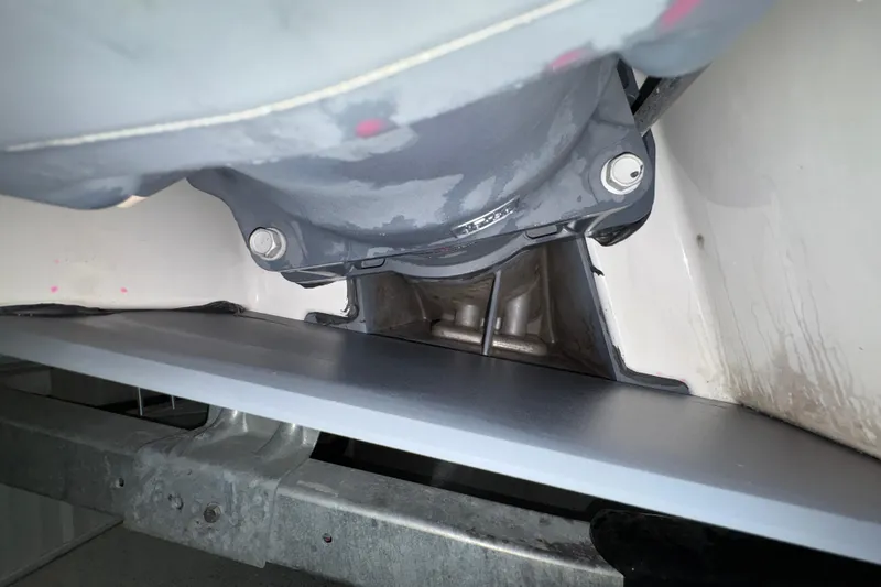 Slide: The Image of 2023 Yamaha Boats 222 FSH Sport interior with white seating and cooler storage. - 47