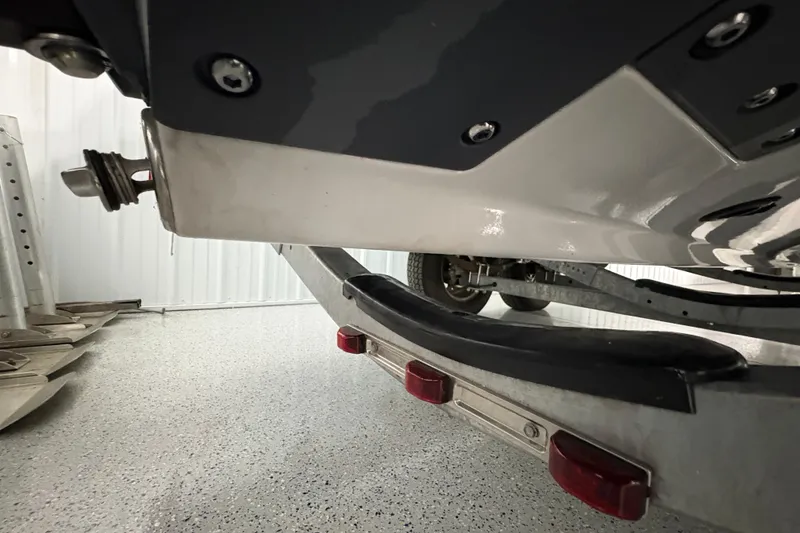 Slide: The Image of 2023 Yamaha Boats 222 FSH Sport T-top and console in a storage facility. - 50