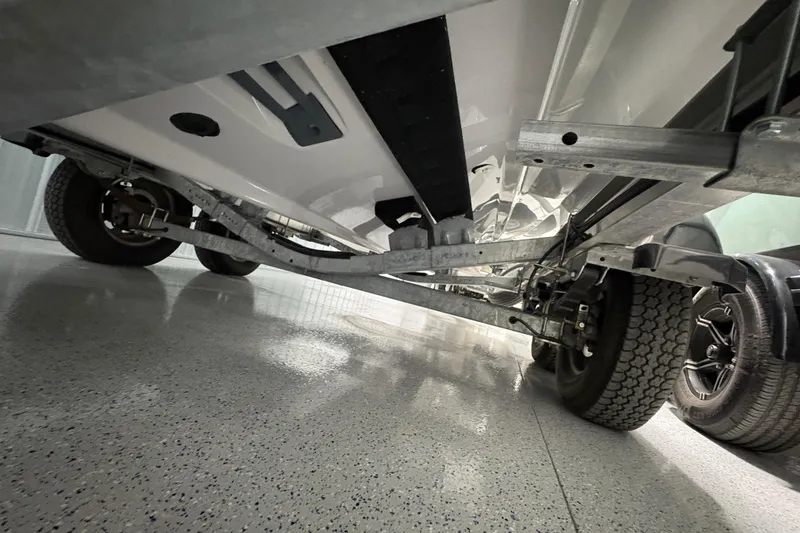 Slide: The Image of 2023 Yamaha Boats 222 FSH Sport T-top frame with black canvas cover. - 51