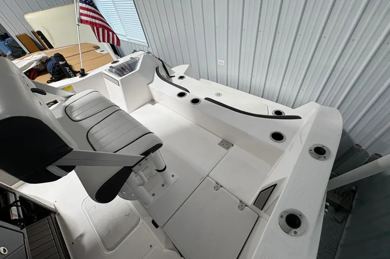 Slide: The Image of 2023 Yamaha Boats 222 FSH Sport interior with steering console and seating. - 53