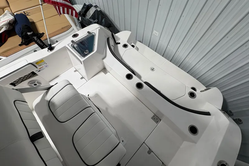 Slide: The Image of 2023 Yamaha Boats 222 FSH Sport dashboard with steering wheel and controls in a sleek design. - 54