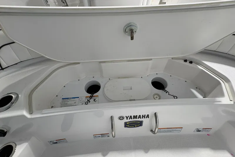 Slide: The Image of 2023 Yamaha Boats 222 FSH Sport interior with steering console and navigation equipment. - 55