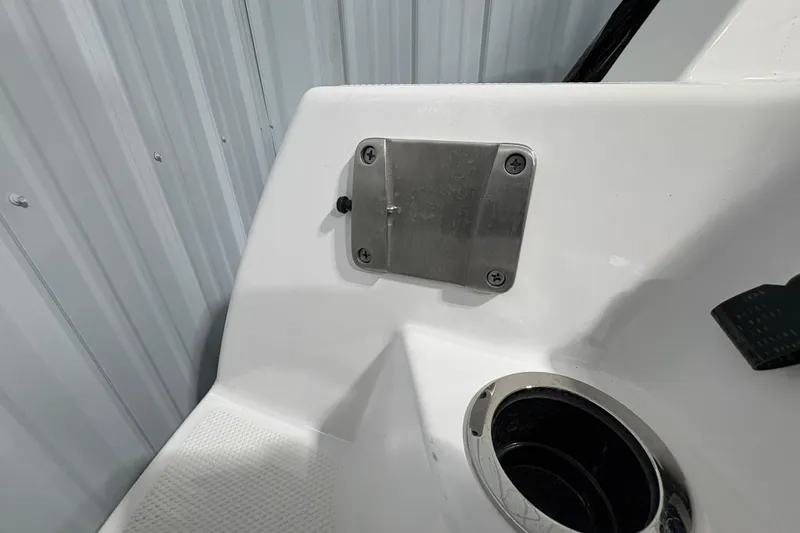 Slide: The Image of 2023 Yamaha Boats 222 FSH Sport interior with white seating and steering wheel. - 57