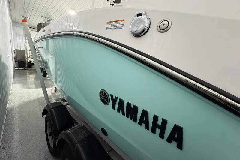 Slide: The Image of 2023 Yamaha Boats 222 FSH Sport in storage, featuring sleek design and modern amenities. - 6