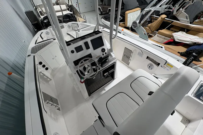 Slide: The Image of 2023 Yamaha Boats 222 FSH Sport storage compartment with black and gray interior. - 68