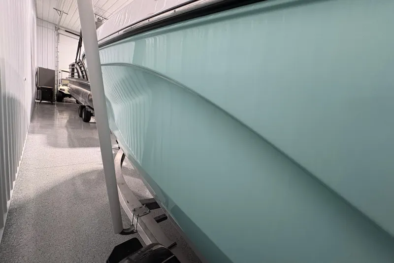 Slide: The Image of 2023 Yamaha Boats 222 FSH Sport in storage, showcasing sleek design and modern features. - 7