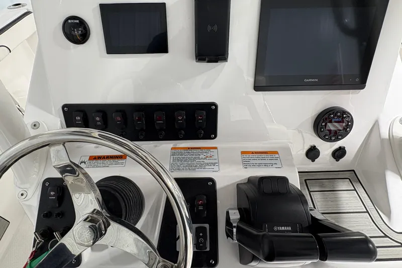 Slide: The Image of 2023 Yamaha Boats 222 FSH Sport interior, featuring seating and storage compartments. - 76