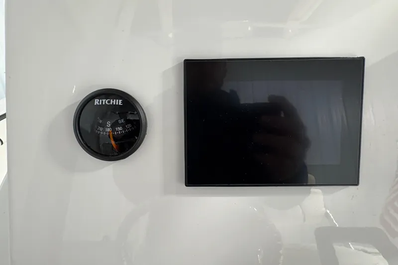 Slide: The Image of 2023 Yamaha Boats 222 FSH Sport interior with seating and storage compartments. - 77