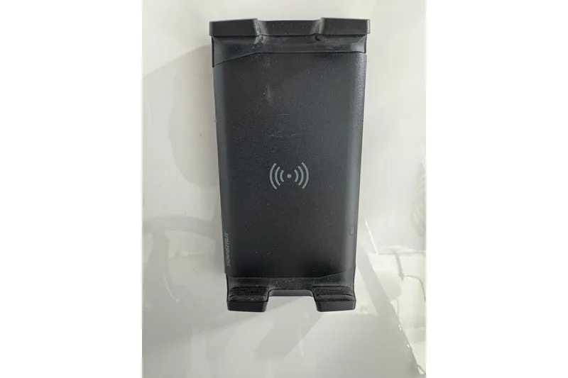 Slide: The Image of 2023 Yamaha Boats 222 FSH Sport interior storage compartment with sleek design and cup holders. - 78