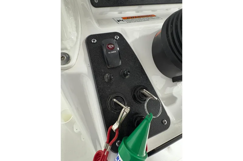 Slide: The Image of 2023 Yamaha Boats 222 FSH Sport interior with white seating and storage compartments. - 82