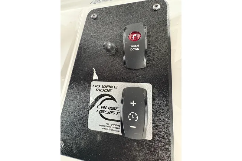 Slide: The Image of 2023 Yamaha Boats 222 FSH Sport interior with seating and T-top in a showroom. - 83