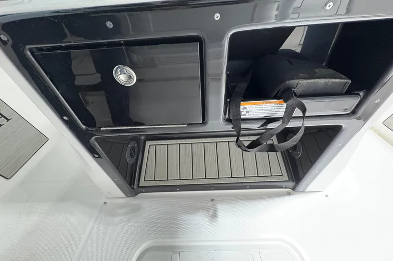 Slide: The Image of Interior view of 2023 Yamaha Boats 222 FSH Sport, showcasing storage compartment details. - 85
