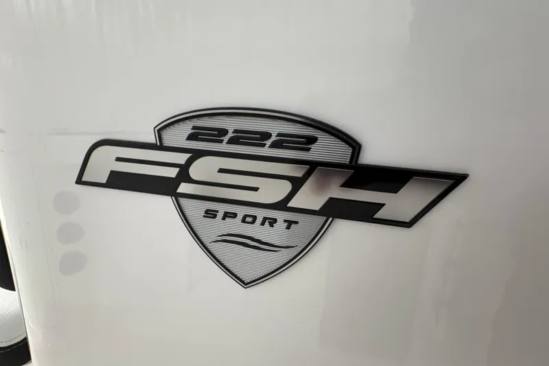 Slide: The Image of 2023 Yamaha Boats 222 FSH Sport interior seating, featuring sleek white upholstery and modern design. - 88