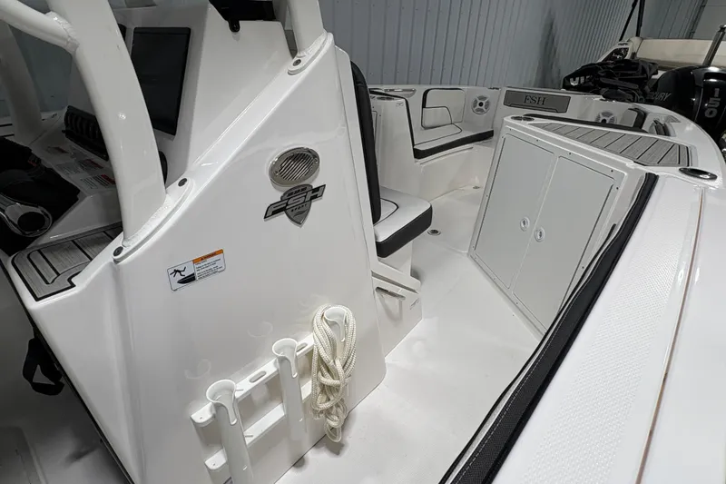 Slide: The Image of 2023 Yamaha Boats 222 FSH Sport interior with white cushioned seating and cup holders. - 93