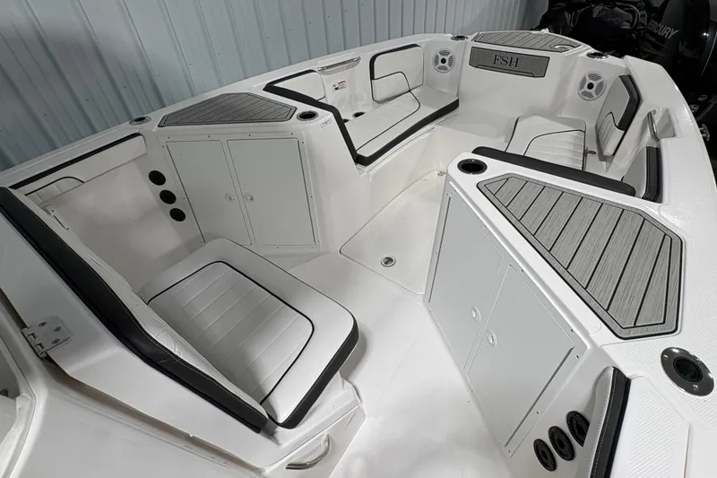 Slide: The Image of 2023 Yamaha Boats 222 FSH Sport anchor compartment with rope and metal fittings. - 94