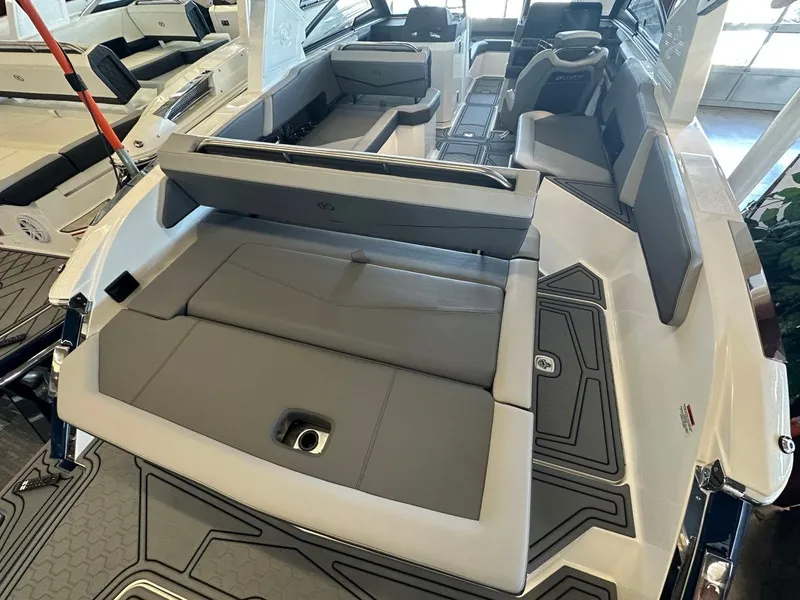 Slide: The Image of Interior of a 2023 Cobalt R6 Surf boat with gray seating. - 10