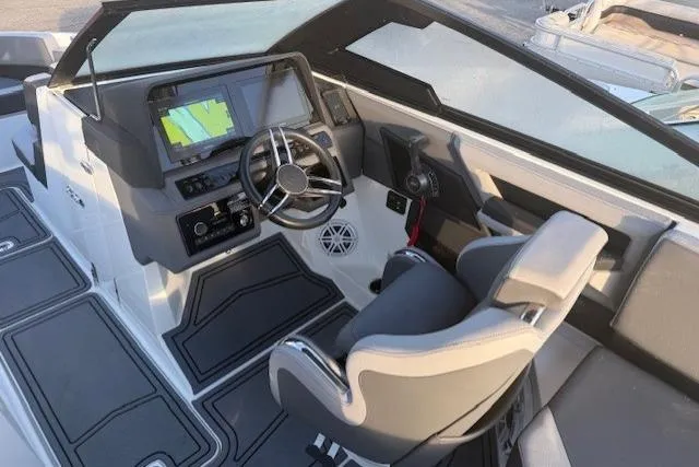 Slide: The Image of 2023 Cobalt R6 Surf boat cockpit with modern steering and navigation system. - 17