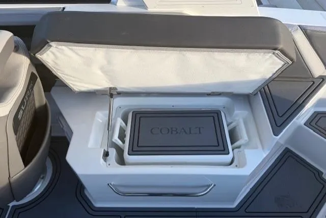 Slide: The Image of 2023 Cobalt R6 Surf boat interior with open storage compartment. - 19