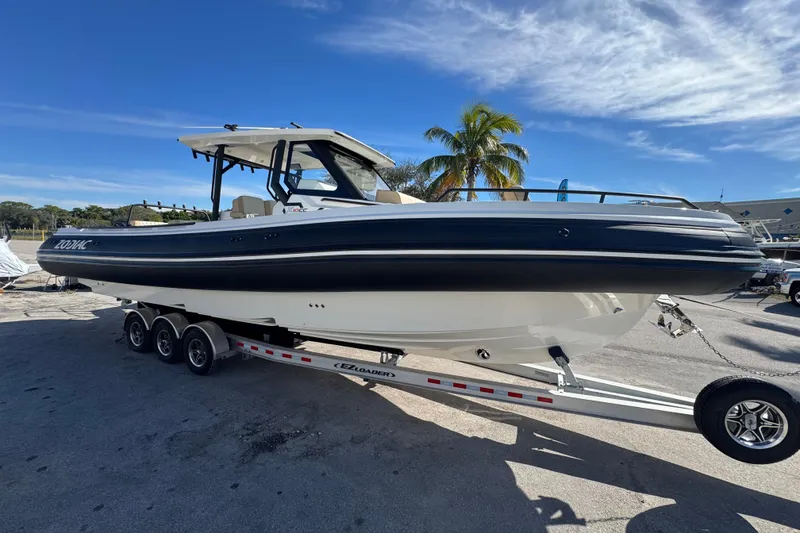 The Image of 2026 Zodiac X10CC boat on trailer under clear blue sky. - 0