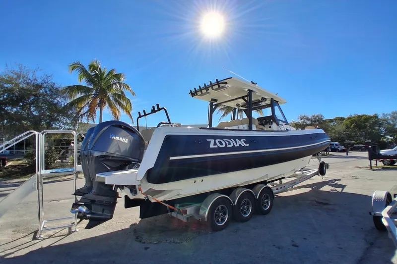 Slide: The Image of 2026 Zodiac X10CC boat with Yamaha engine on trailer under sunny sky. - 1
