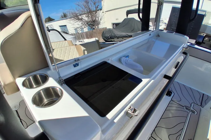 Slide: The Image of 2026 Zodiac X10CC boat interior with sink, cup holders, and seating area. - 11