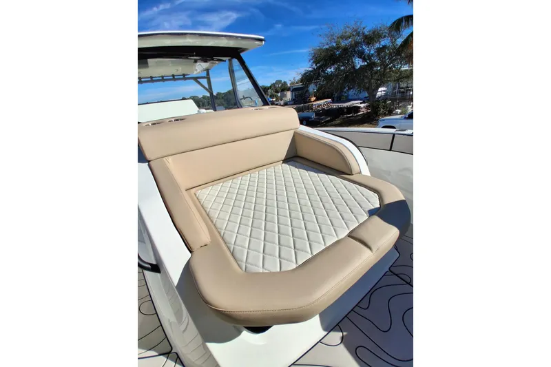 Slide: The Image of Luxurious seating on 2026 Zodiac X10CC boat with quilted upholstery under clear blue sky. - 14