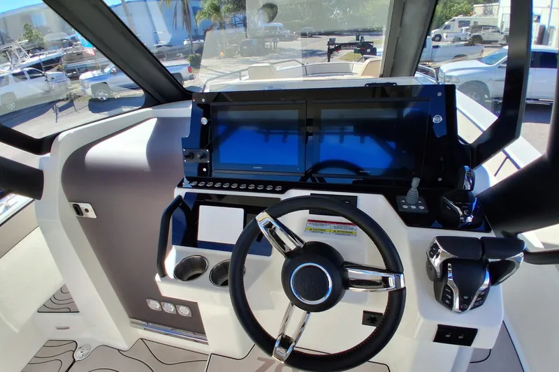Slide: The Image of 2026 Zodiac X10CC boat cockpit with modern steering and dual screens. - 6