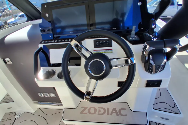 Slide: The Image of Control panel of 2026 Zodiac X10CC boat with steering wheel and navigation screens. - 8