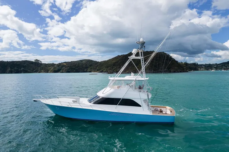The Image of 2007 Viking 64 Convertible yacht cruising on turquoise waters under a cloudy sky. - 0