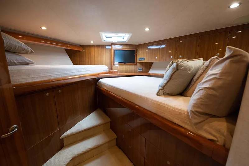 Slide: The Image of Luxurious cabin interior of 2007 Viking 64 Convertible yacht with wooden finish and cozy bedding. - 11