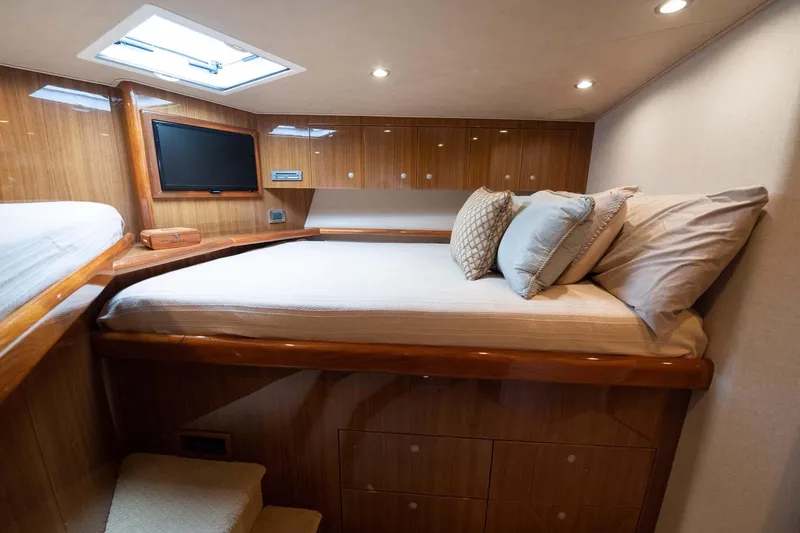 Slide: The Image of Luxurious cabin interior of 2007 Viking 64 Convertible yacht with cozy bedding and wooden finishes. - 12