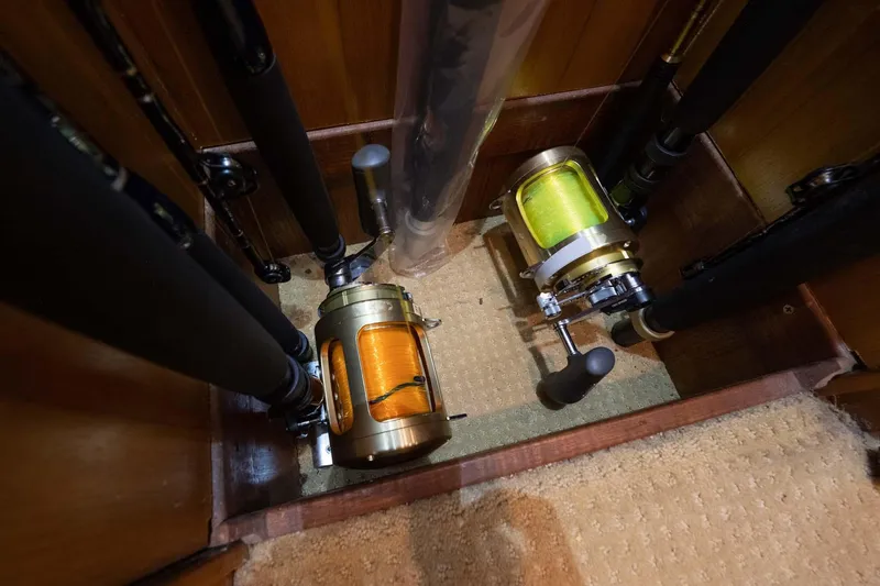 Slide: The Image of Fishing rods and reels stored in a 2007 Viking 64 Convertible yacht compartment. - 17