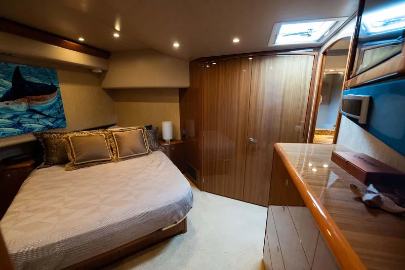 Slide: The Image of Luxurious bedroom interior of 2007 Viking 64 Convertible yacht with elegant wood finishes. - 21