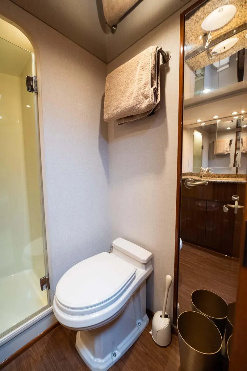 Slide: The Image of 2007 Viking 64 Convertible yacht bathroom with shower, toilet, and modern fixtures. - 24