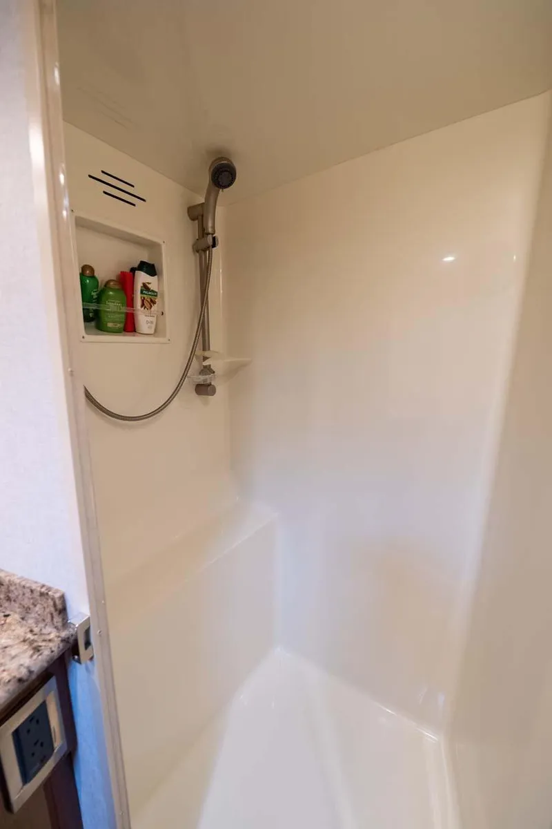 Slide: The Image of Shower area in 2007 Viking 64 Convertible yacht with built-in shelf and handheld showerhead. - 26