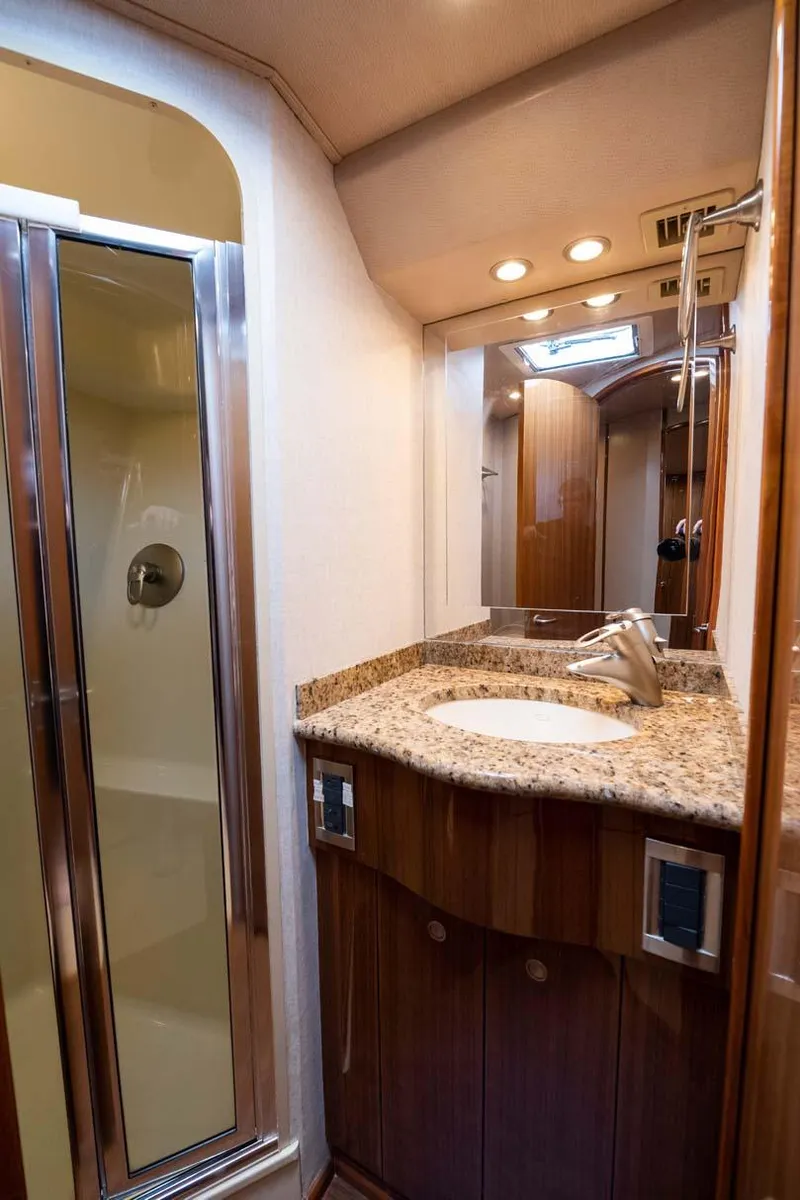 Slide: The Image of Luxurious bathroom in 2007 Viking 64 Convertible yacht with granite countertop and shower. - 27