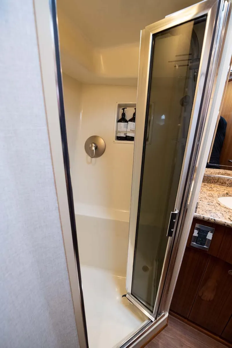 Slide: The Image of Shower area in 2007 Viking 64 Convertible yacht with glass door and modern fixtures. - 29